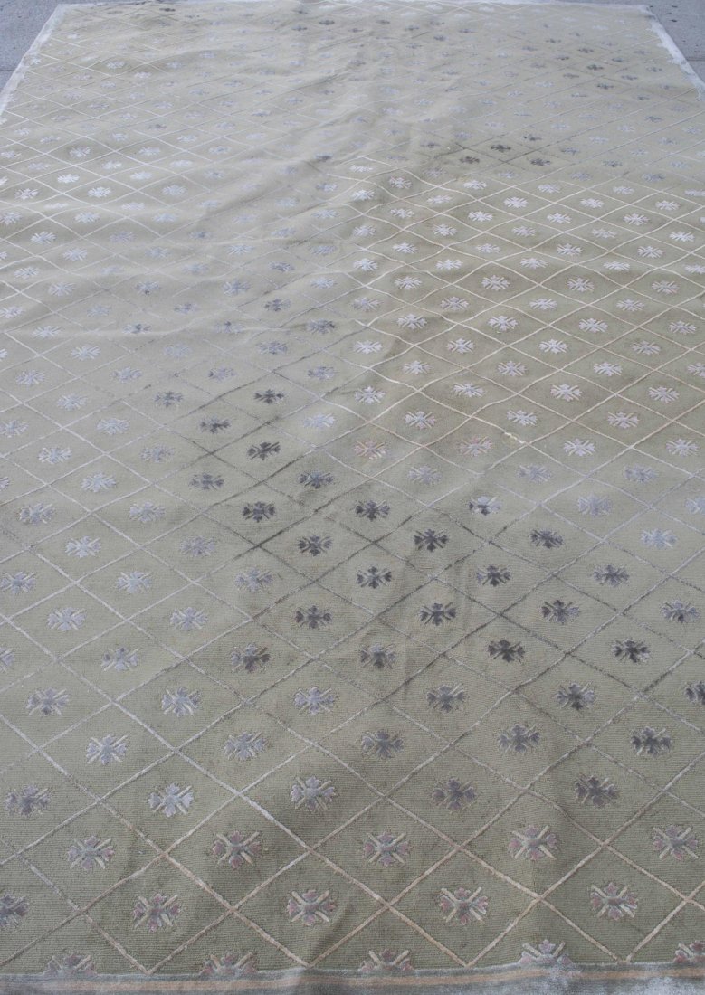 Stark Carpet: Allover repeating medallion and geometric decoration on a gray ground. 16 feet x 10 feet 6 inches. Notice to bidders: Condition reports and additional photographs are provided by request as a courtesy