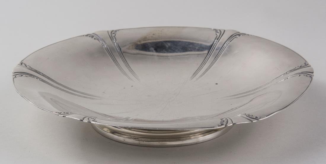 Watson Co., Sterling Silver Cake Plate: Tuscany pattern, circular footed cake stand. Diameter 11 inches, 664 grams. Notice to bidders: Condition reports and additional photographs are provided by request as a courtesy to our clients, as suc