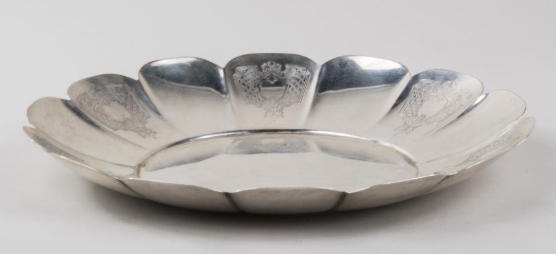 C.D. Peacock Sterling Silver Center Bowl: Circular bowl with scalloped rim and engraved armorial decoration. Diameter 12 inches, 812 grams. Notice to bidders: Condition reports and additional photographs are provided by request as a courtesy 