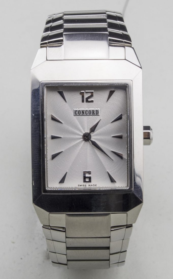 Concord Man's Watch: Guilloche enamel dial, Arabic 12 and 6 and baton hours, no. 1318997, stainless steel band. Notice to bidders: Condition reports and additional photographs are provided by request as a courtesy to our 