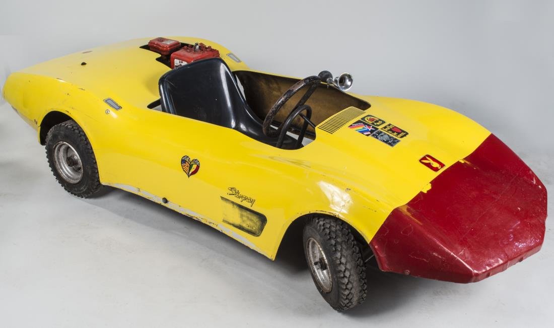 Yellow 1970's Corvette Stingray Go Kart: Manufactured by F.W. & Associates, Mansfield, OH, serial number 7011655, with a 3 horsepower Briggs & Stratton Engine, has spark. Height 22 inches, width 34 inches, depth 86 inches. Notice to bidders:
