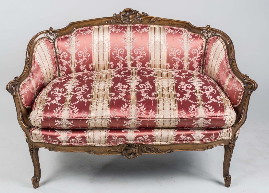 Louis XV Style Walnut Canape: Carved crest rail, upholstered back and arms, cushion seat, slightly cabriole legs. Height 33 inches, width 48 inches, depth 27 inches. Notice to bidders: Condition reports and additional photographs 