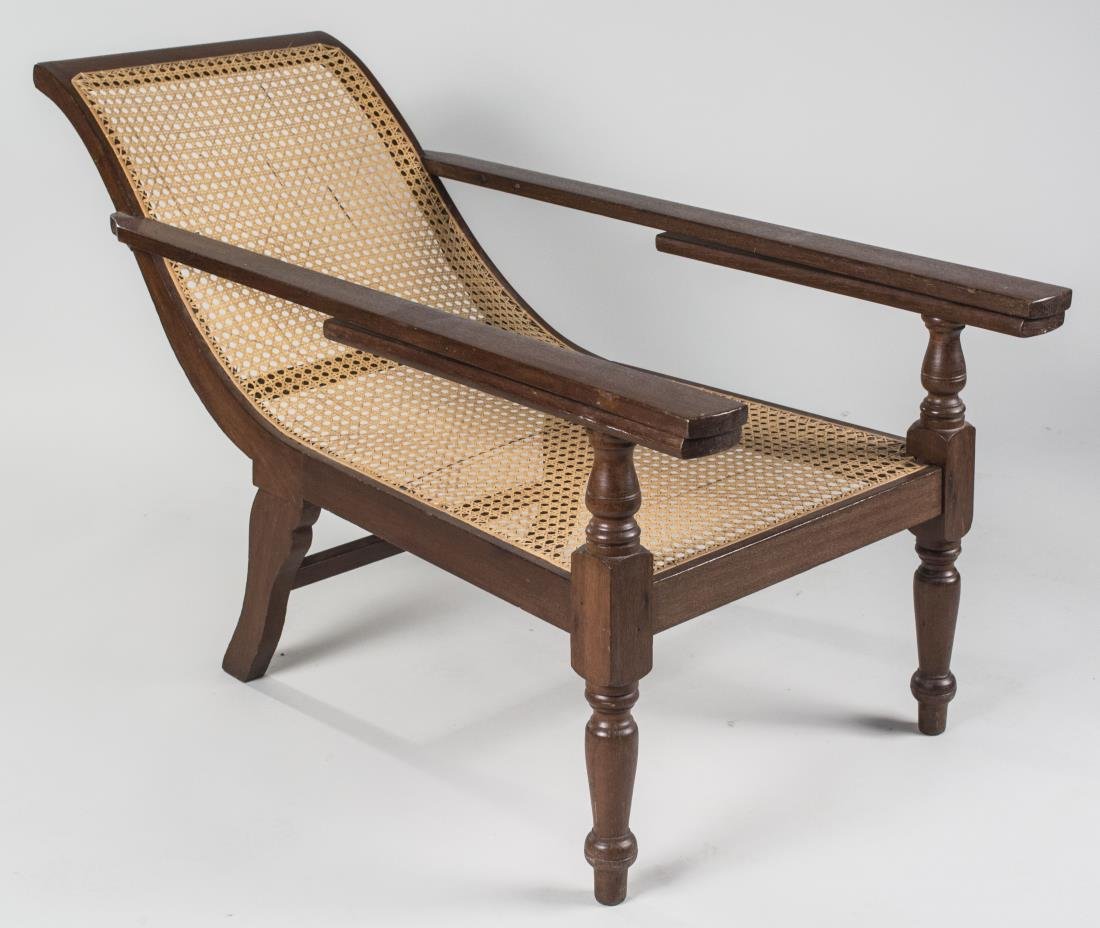 Caned Planter's Armchair: Caned sloped back/seat, arms with extendable leg supports, turned front legs. Height 29 inches, width 24 inches, length 51 inches. Notice to bidders: Condition reports and additional photographs are p