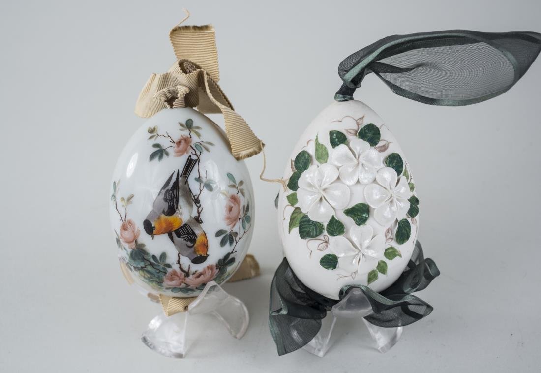 Two Russian Porcelain Easter Eggs: One decorated with two birds on a flowering branch on a light gray ground, the other with applied white flower decoration on a white ground. Height, 3 1/2 inches. Provenance: From the Collection of Er