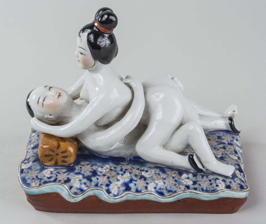 Chinese Porcelain Erotica Figure: Circa 1920's, modeled as two figures on a famille verte on blue ground cushion. Height 5 3/4 inches. Notice to bidders: Condition reports and additional photographs are provided by request as a courte