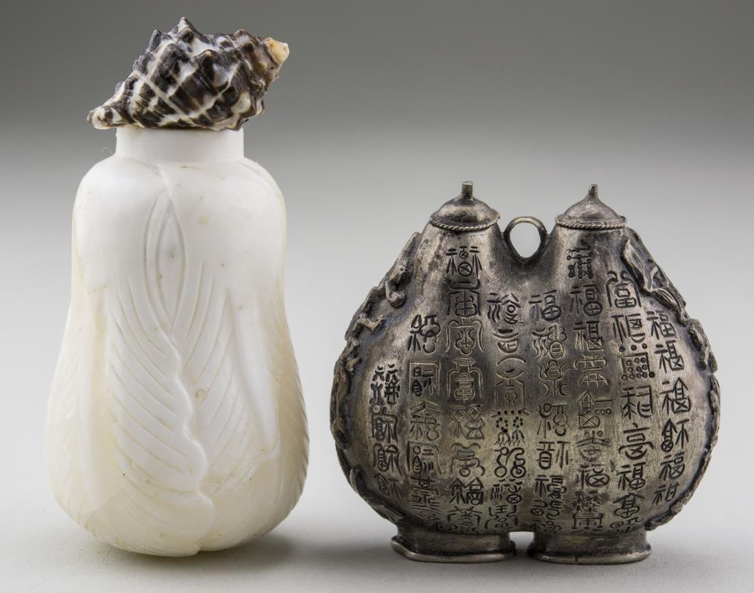 Two Chinese Snuff Bottles: One, a shell carved fruit bottle and the other a metal double bottle with Chinese characters. Shell bottle, height 2 2/3 inches. Provenance: From the Collection of Erwin A. Raible Notice to bidders: C