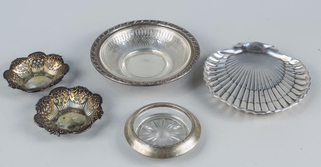 Group of Small Sterling and Silver Plated Dishes: Comprising a Frank Whiting sterling silver dish with glass liner and a coaster, a Gorham shell form dish and two silver plated reticulated dishes. Notice to bidders: Condition reports and additional p
