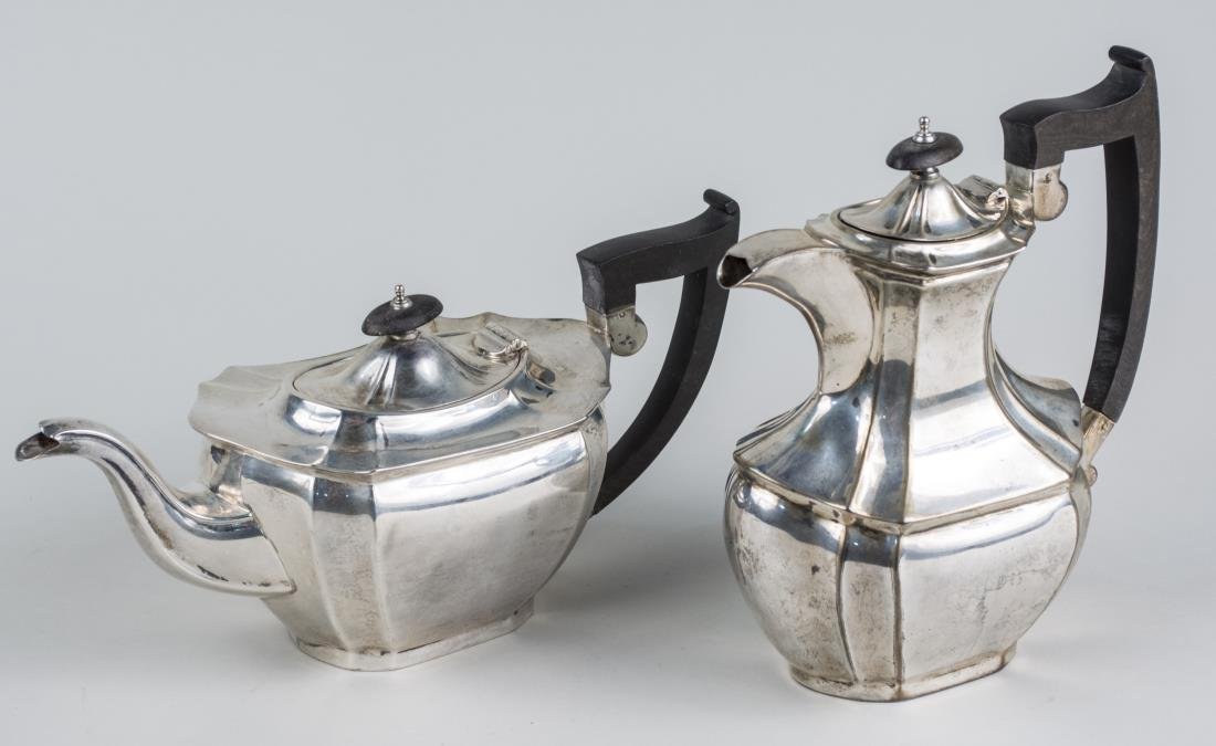English Silver Coffee Pot and Teapot: Maker's mark of EV, Sheffield, 1927, with wood handle and finial. Total 1270 grams, all inclusive. Notice to bidders: Condition reports and additional photographs are provided by request as a courtesy