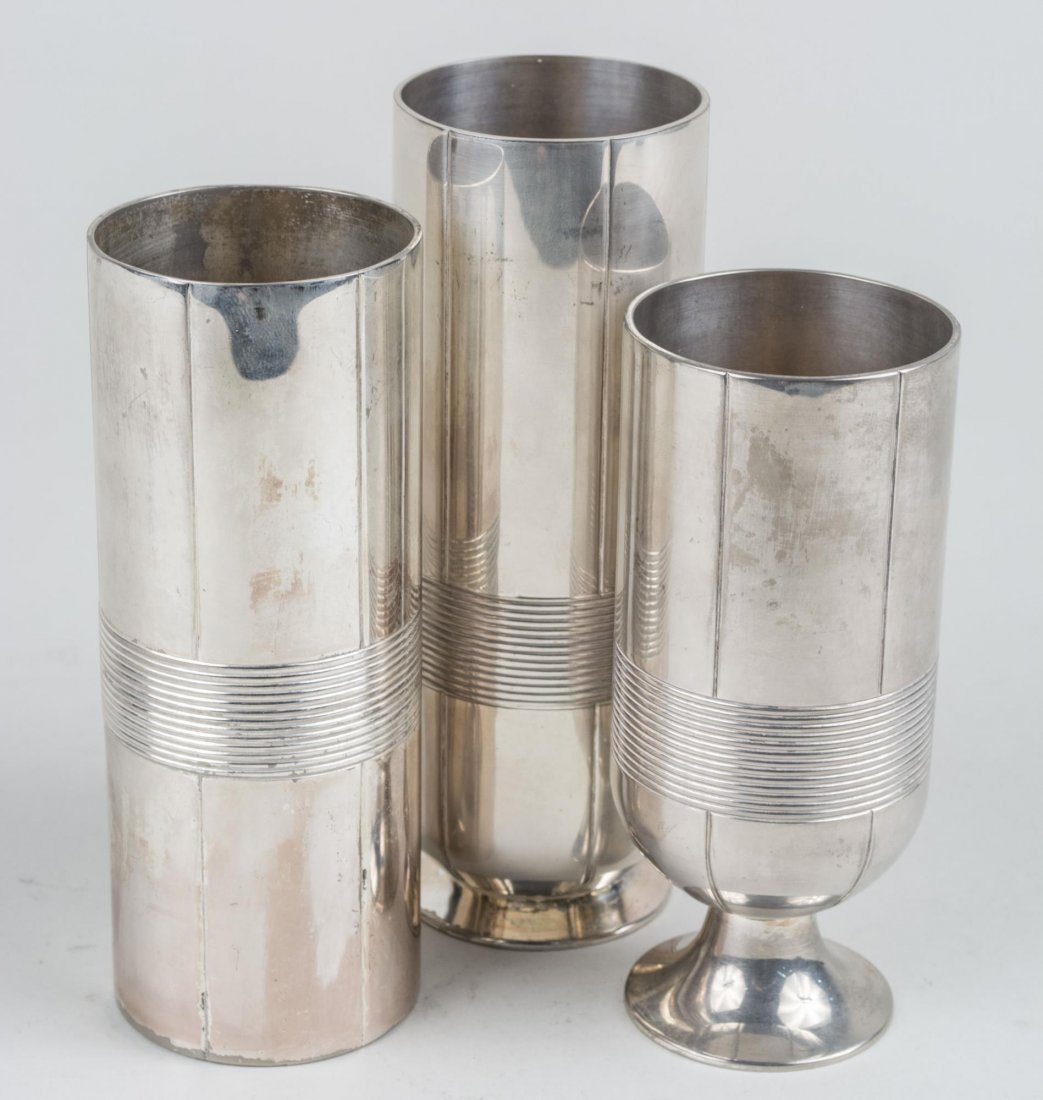 Set of Three Silver Plated Vera Wang Vases: Cylindrical with ribbed decoration. Notice to bidders: Condition reports and additional photographs are provided by request as a courtesy to our clients, as such any condition report is only an opinio