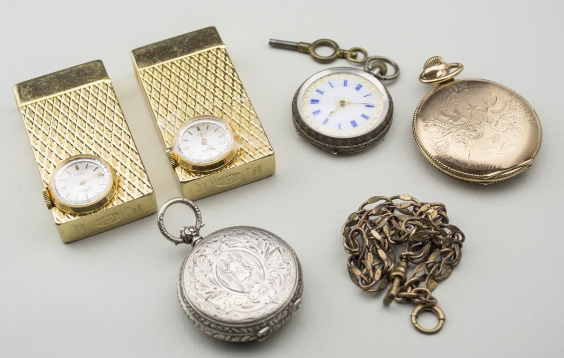 Group of Pocket Watches and Lighters: Including an American Waltham gold filled hunt case pocket watch, a Swiss silver open face key wind pocket watch, an English silver open face pocket watch, two gold tone cigarette lighters with watch