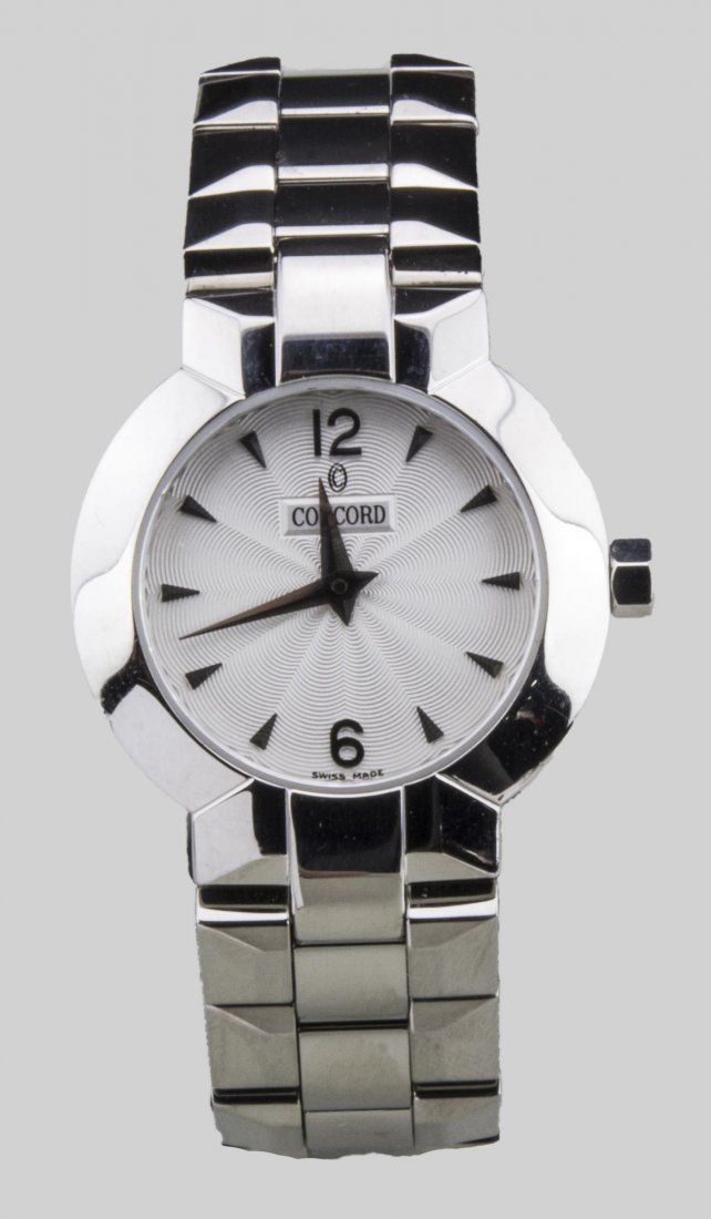 Lady's Concord Watch: Guilloche enamel dial with Arabic 12 and 6 and baton hours, signed, no.14 84 1843 and 11205808, stainless steel band. Notice to bidders: Condition reports and additional photographs are provided by re