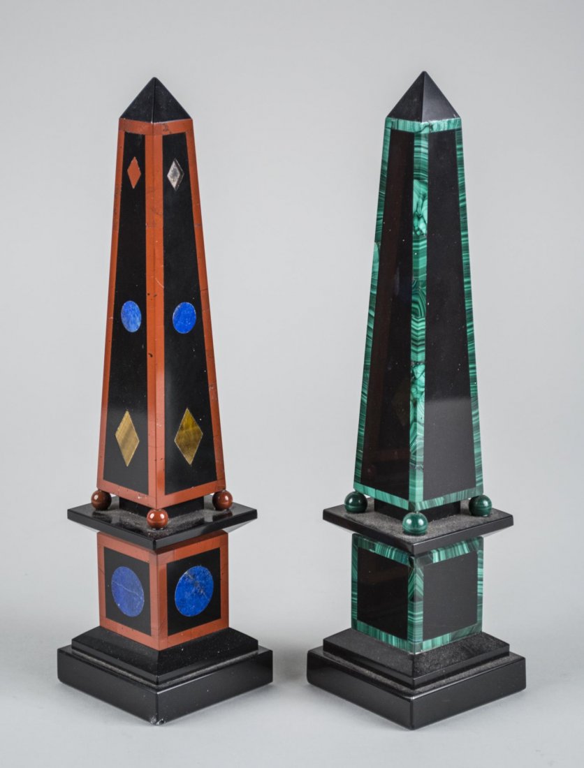 Two Marble Obelisks: One with malachite accents, the other with various mineral accents. Height 12 inches. Notice to bidders: Condition reports and additional photographs are provided by request as a courtesy to our clien