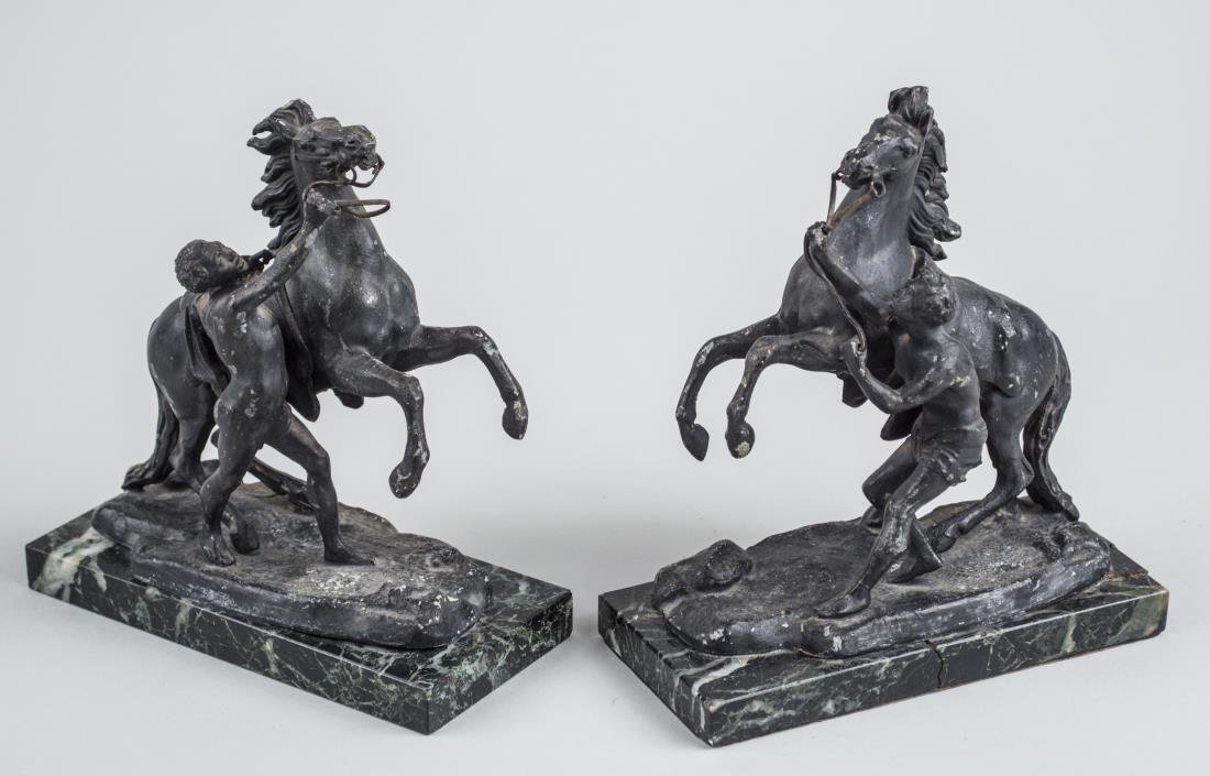Pair of Parisian Spelter Bookends: Each depicting a moor handling a horse on a black marble base, one with foundry mark. Height 7 1/2 inches. Notice to bidders: Condition reports and additional photographs are provided by request as a 