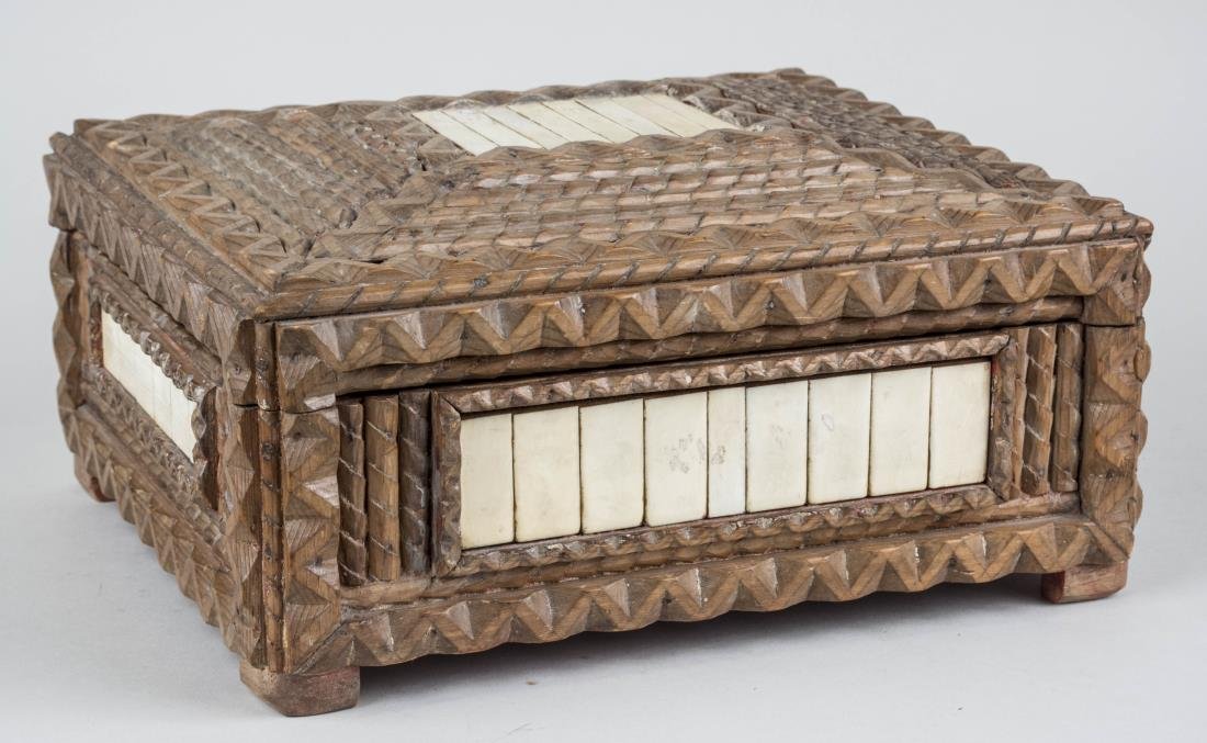 Tramp Art Carved Wood Box: Bone panel inlay decoration. Height 6 inches, width 12 1/2 inches, depth 10 1/4 inches. Notice to bidders: Condition reports and additional photographs are provided by request as a courtesy to our cli