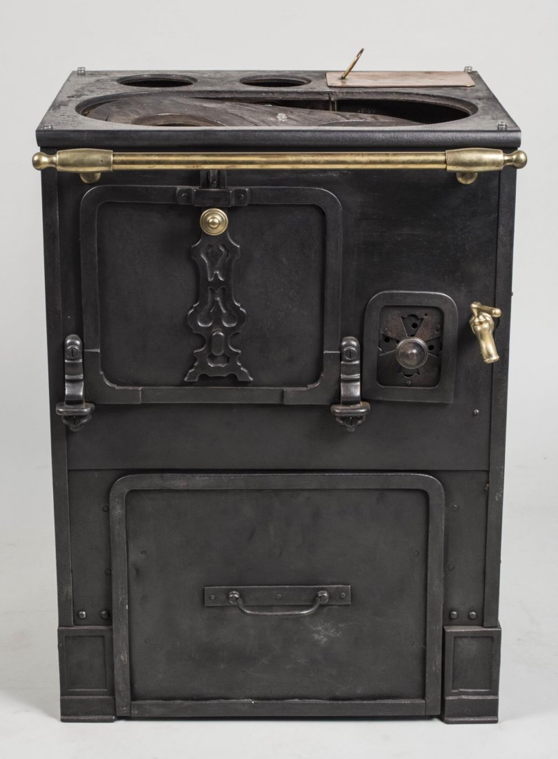 Cast Iron Stove: With water spigot. Height 30 inches, width 22 inches, depth 21 inches. Notice to bidders: Condition reports and additional photographs are provided by request as a courtesy to our clients, as such any