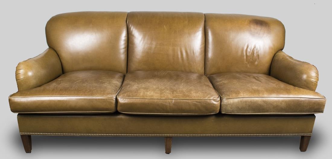 Leather Sofa: Brown leather three seat sofa with three chair back, cushion seats, on square wood legs. Height 35 inches, width 88 inches, depth 42 inches. Notice to bidders: Condition reports and additional photogr