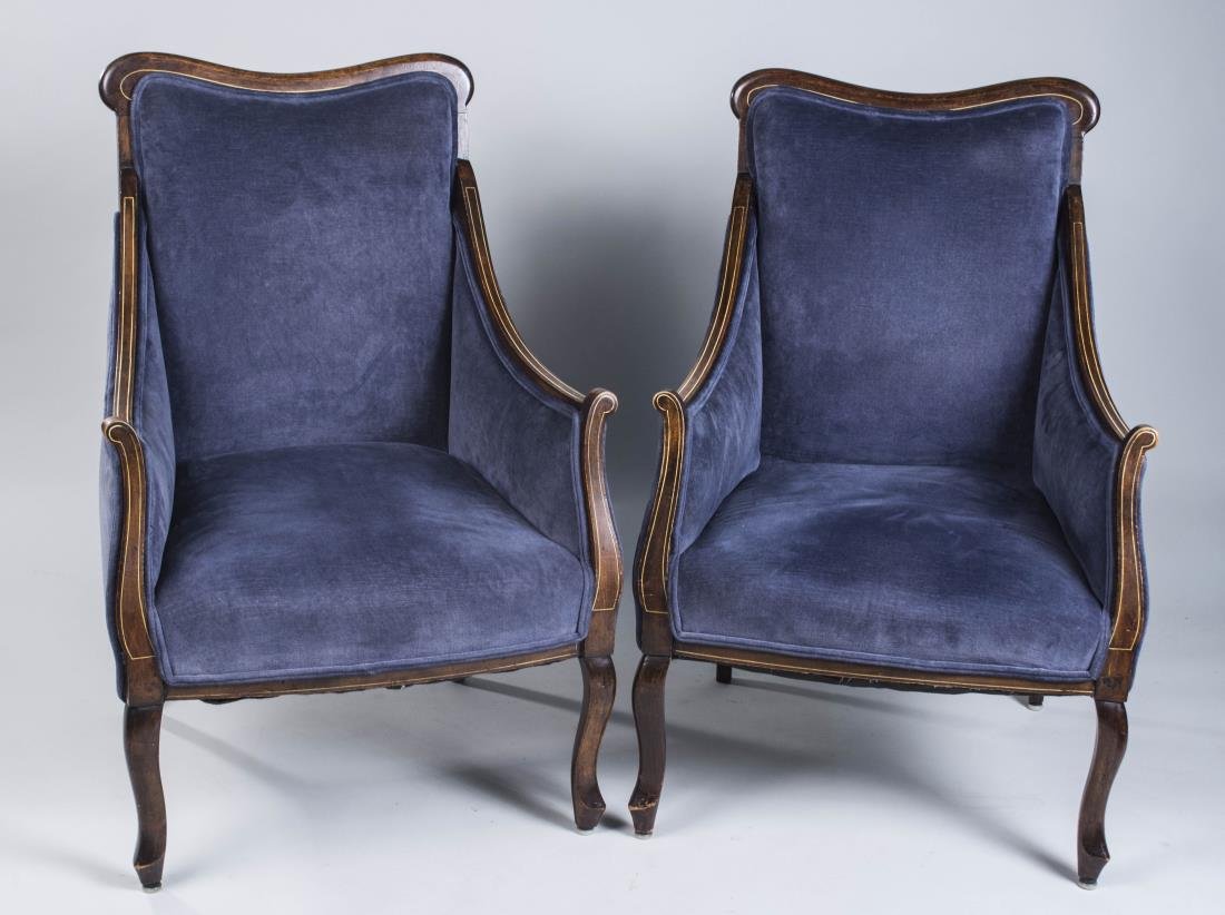 Pair of Upholstered Bergeres: Each navy blue upholstered chair with rectangular back, cabriole legs. Height 38 inches, width 24 inches, depth 26 inches. Notice to bidders: Condition reports and additional photographs are provided 