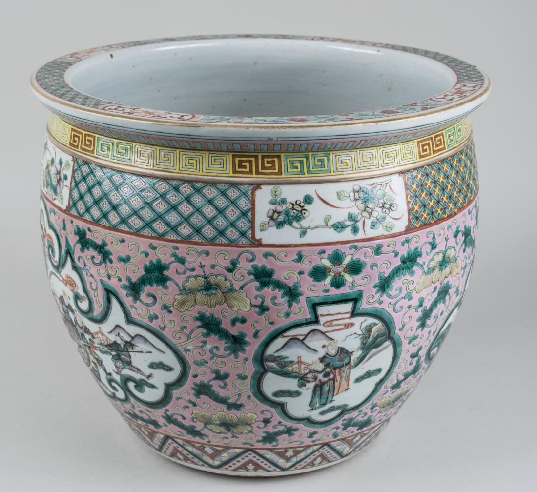 Chinese Porcelain Fish Bowl: Stylized flower and cloud decoration on a pink ground. Height 14 inches, diameter 16 inches. Notice to bidders: Condition reports and additional photographs are provided by request as a courtesy to ou