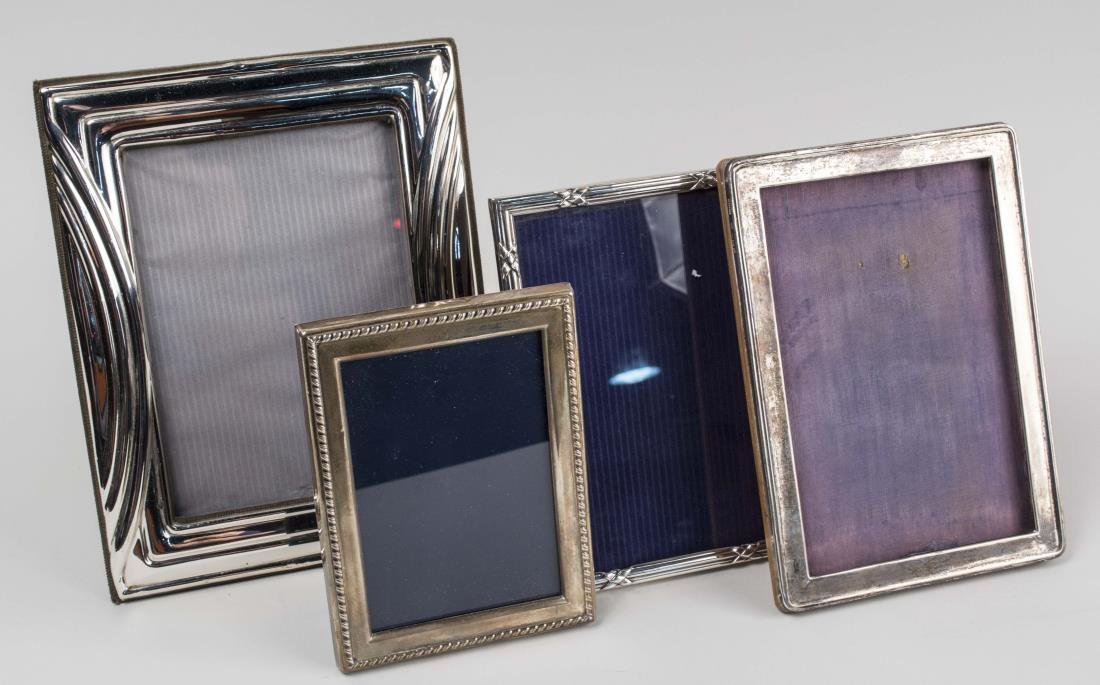 Four Silver Picture Frames: Various makers and styles. Notice to bidders: Condition reports and additional photographs are provided by request as a courtesy to our clients, as such any condition report is only an opinion and sho