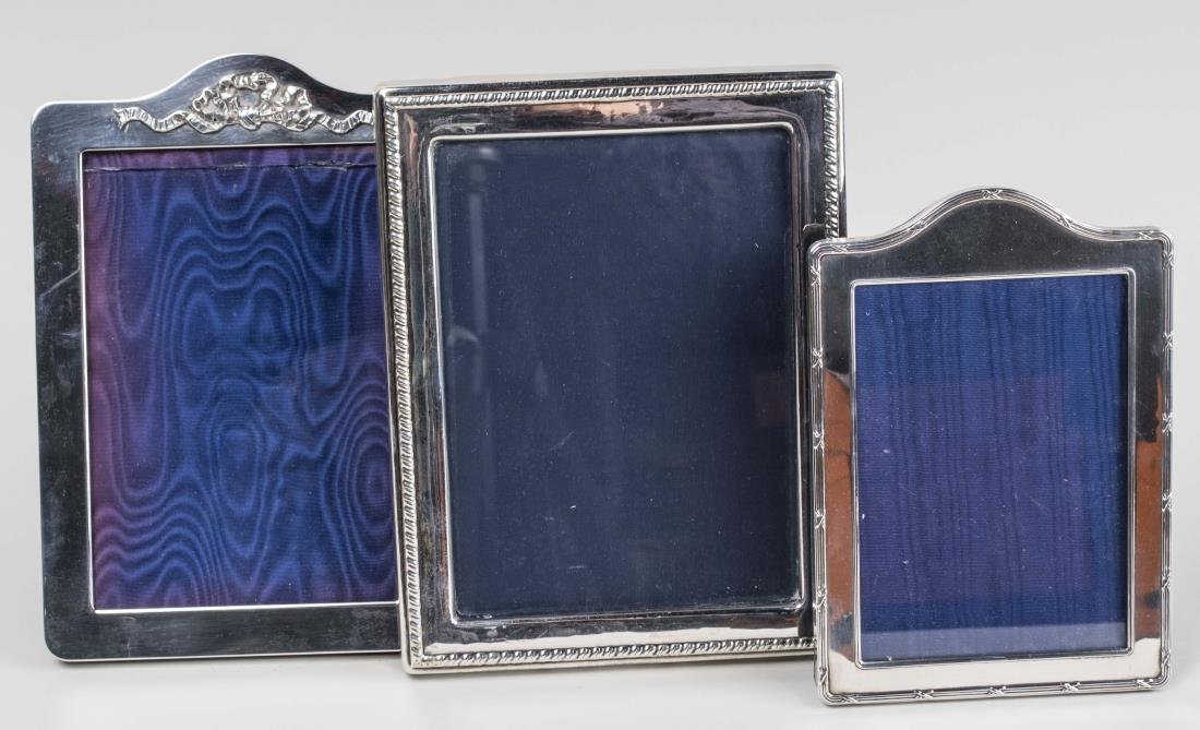 Three English Silver Picture Frames: Three rectangular frames, hold 5 x 7 photo. Notice to bidders: Condition reports and additional photographs are provided by request as a courtesy to our clients, as such any condition report is only a