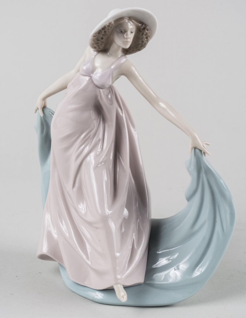 Lladro Porcelain Figure: Spring Dance, number 5663, sculpted by Jose Puche, issued in 1990 and retired in 2001. Height 8 7/8 inches. Notice to bidders: Condition reports and additional photographs are provided by request as a