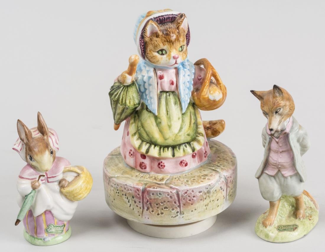 Three Beatrix Potter Figures: Comprising a fox, a rabbit, and a cat music box figurine. Tallest height 7 inches. Notice to bidders: Condition reports and additional photographs are provided by request as a courtesy to our clients,
