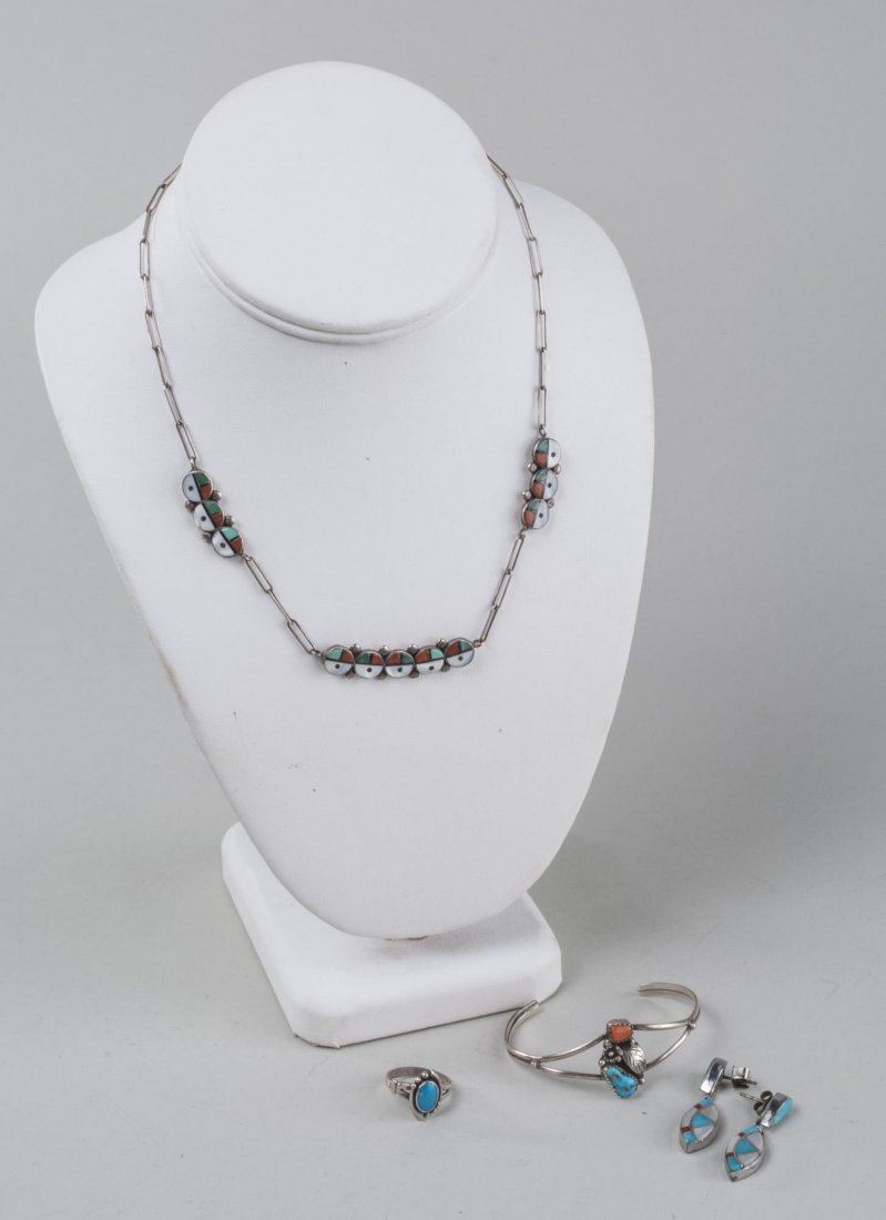 Group of Native American Jewelry: Including a Navajo bangle, a Zuni Sunface chain necklace and a pair of Zuni pierced earrings, all with turquoise and coral stones accents. Neck chain, length 16 inches. Provenance: David Saity Jeweler
