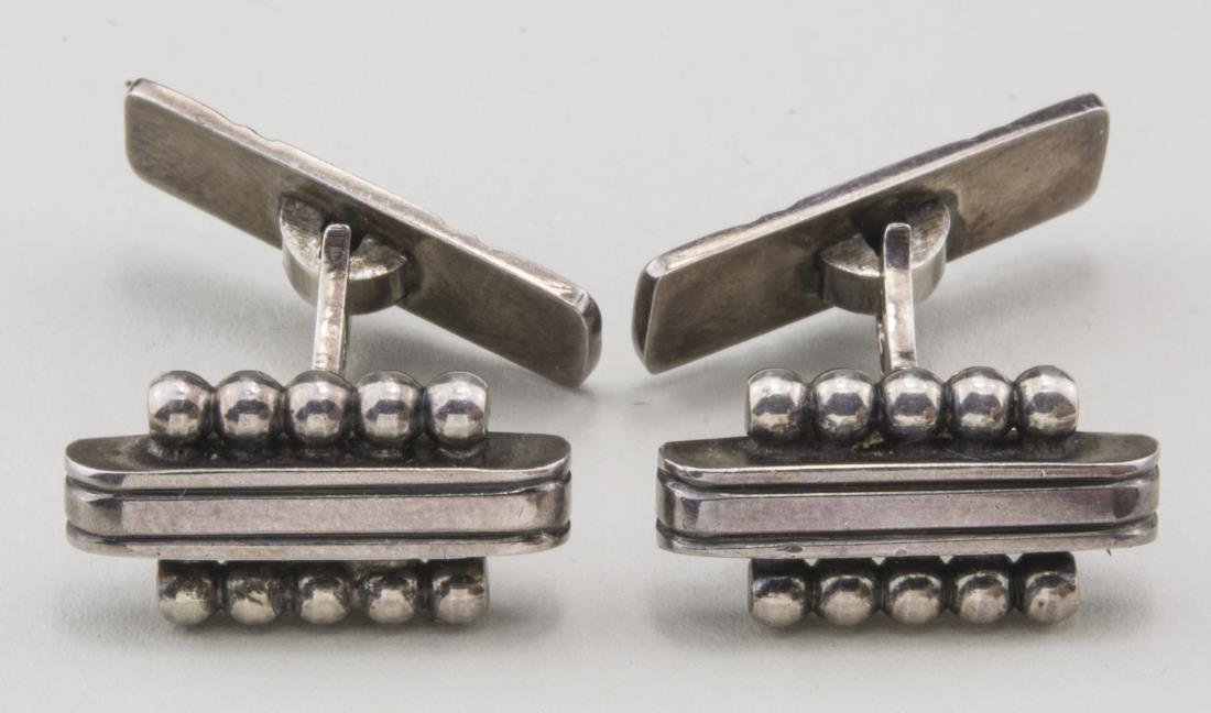 Scandinavian Design Sterling Silver Cufflinks: Mid century style designed as a triple bar flanked on each side by five balls, signed WKR and marked 930. Notice to bidders: Condition reports and additional photographs are provided by request as a c