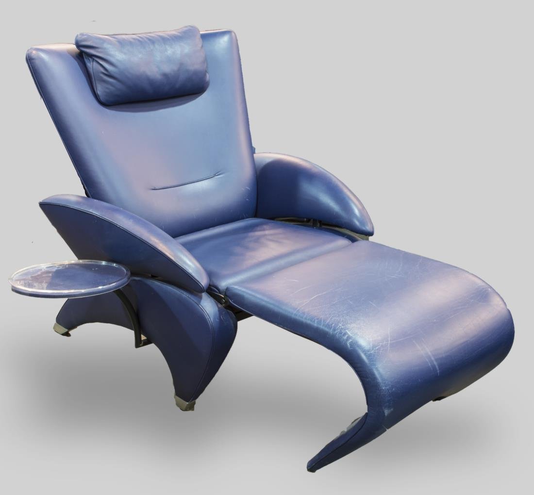 De Sede Lounge Chair: Blue leather upholstery, with attached side table and extendable foot rest. Height 40 inches, width 36 inches, depth closed 37 inches. Notice to bidders: Condition reports and additional photographs a
