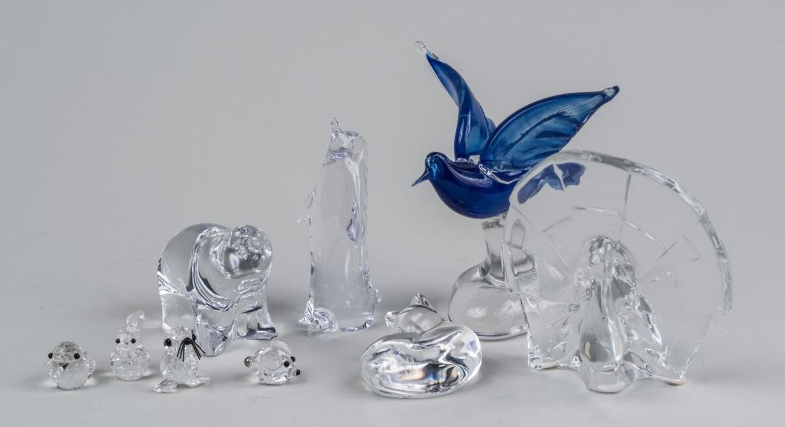 Group of Glass Animals: Including a peacock, a polar bear, a sleeping kitten, a penguin, and a flying bird. Tallest height 5 3/4 inches. Notice to bidders: Condition reports and additional photographs are provided by request