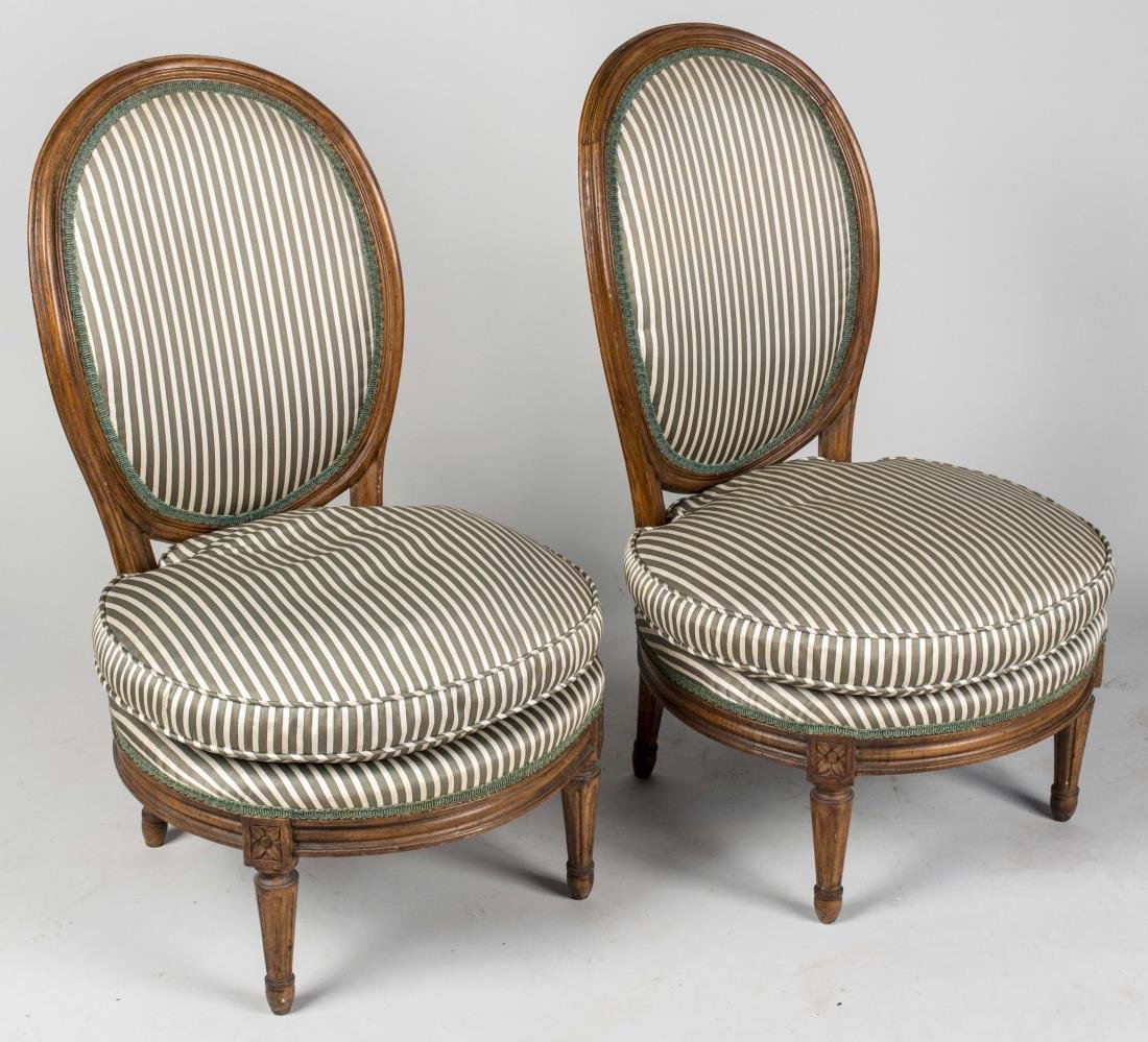 Pair of Louis XVI Style Slipper Chairs: Each with oval upholstered back, cushion seat and fluted tapered legs. Notice to bidders: Condition reports and additional photographs are provided by request as a courtesy to our clients, as such any
