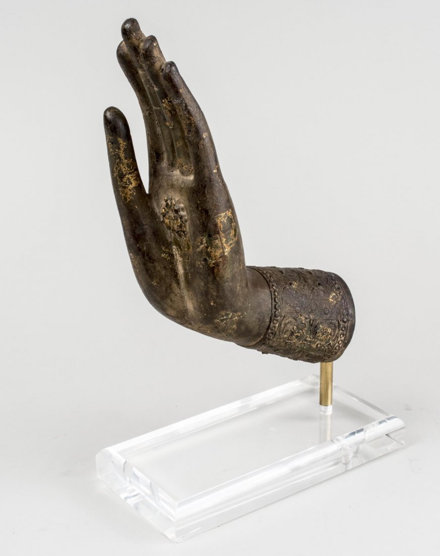 Bronze Hand of Buddha *: Modeled with open palm and mounted on a plexiglass base. Height 12 3/4 inches. Notice to bidders: Condition reports and additional photographs are provided by request as a courtesy to our clients, as