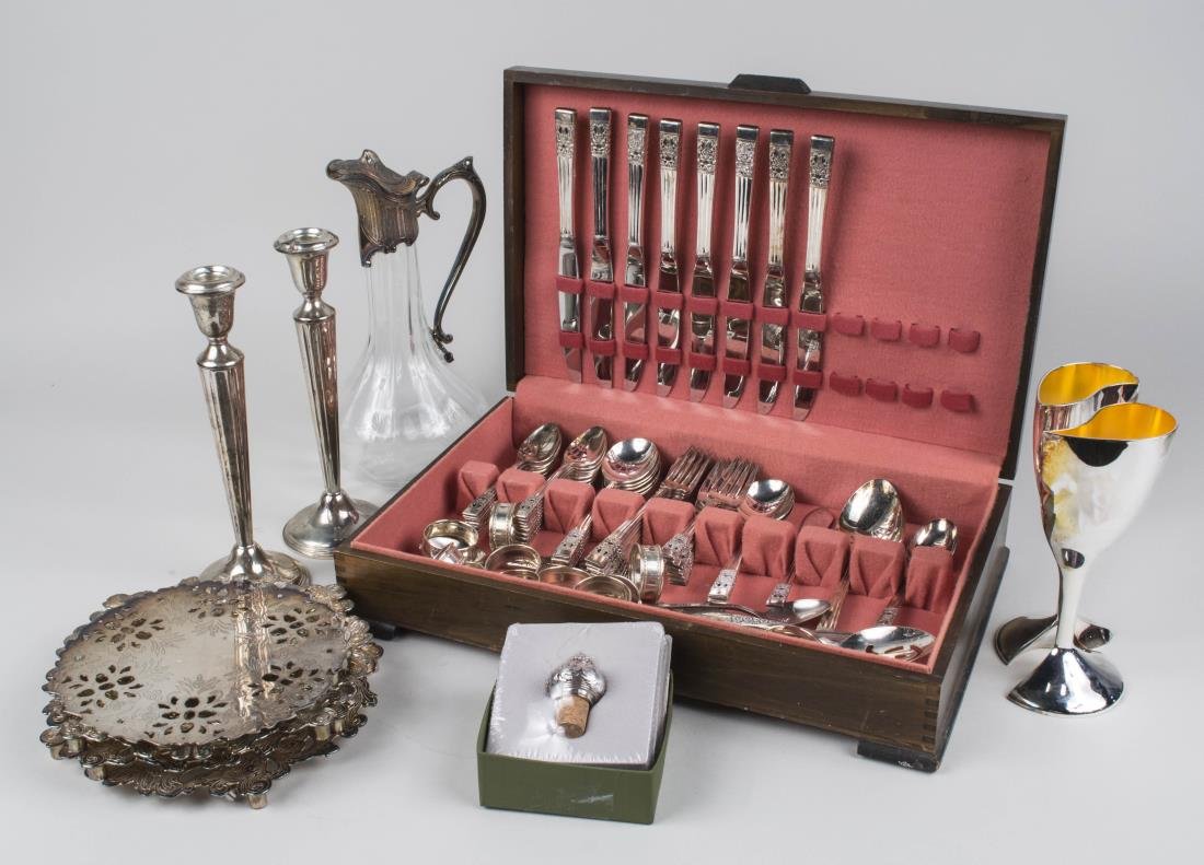 Sterling and Silver Plated Table Articles: Including a pair of weighted candlesticks, a set of napkin rings, a silver plated flatware set. pair of Lenox silver plated wine goblets, set of trivets and a silver plated and glass ewer. etc. Candle