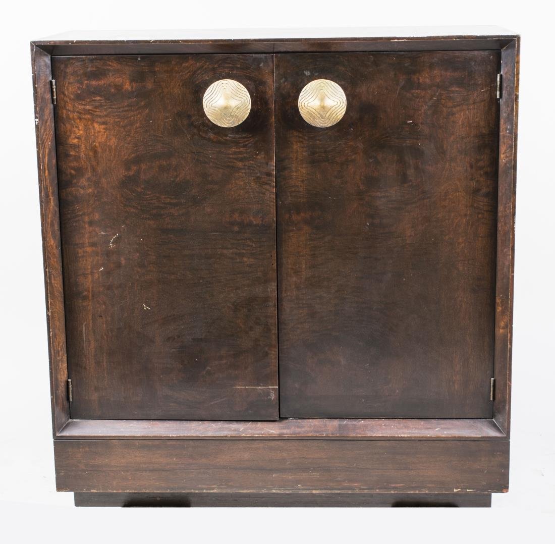 Gilbert Rohde Cabinet: Rectangular top over two doors opening to two shelves, plinth base. Height 40 inches, width 41 inches, depth 17 inches. Notice to bidders: Condition reports and additional photographs are provided by