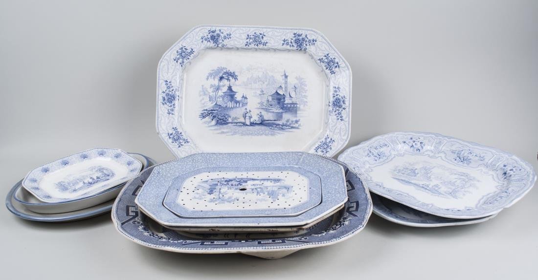 Group of Blue and White Transferware Platters: Seven platters with various patterns, including Syria, Willow, Persia, Columbia, etc.; together with two hand painted pottery platters. Largest platter 18 x 22 1/4 inches. Notice to bidders: Condition