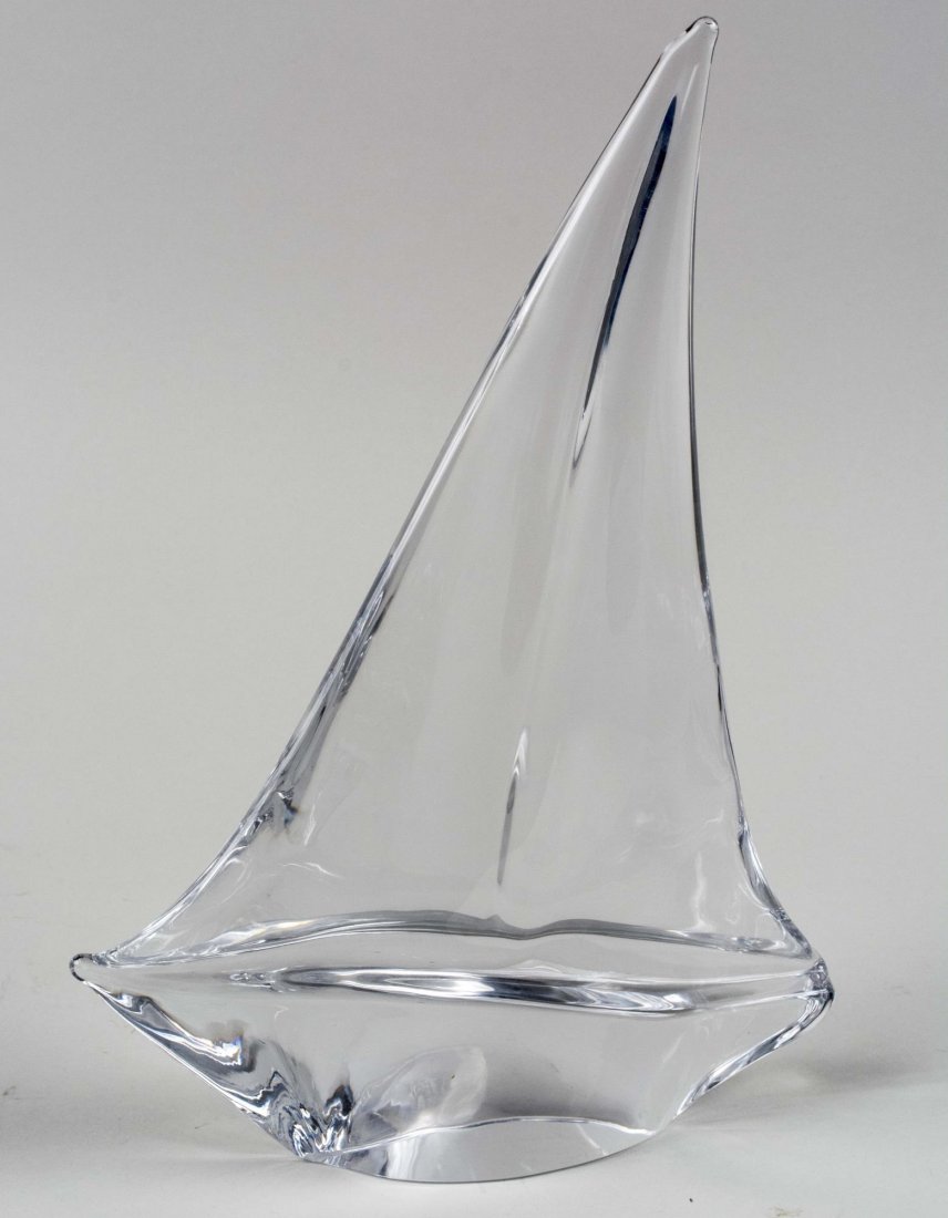 Daum Grand Bateau Sailboat Sculpture: Clear glass abstract form of a single mast sailboat. Height 12 3/4 inches. Notice to bidders: Condition reports and additional photographs are provided by request as a courtesy to our clients, as such