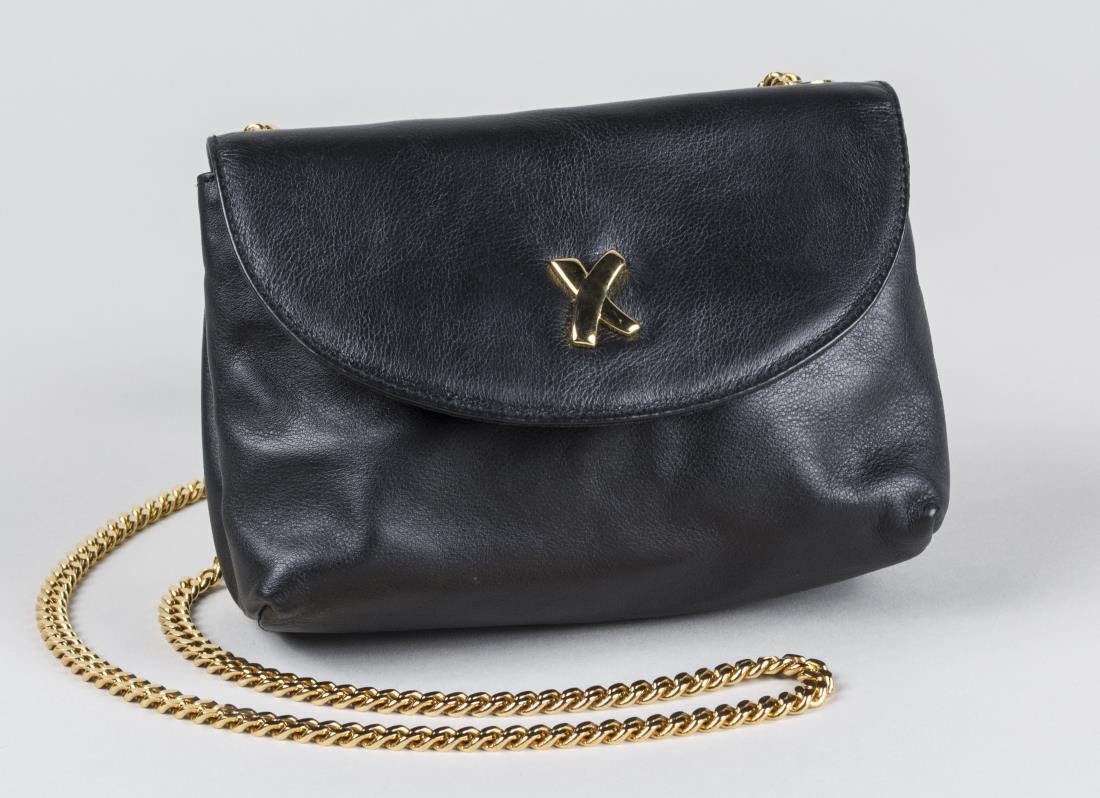 Paloma Picasso Handbag: Black leather bag with goldtone chain, with cloth storage bag. 6 x 7 1/2 inches. Notice to bidders: Condition reports and additional photographs are provided by request as a courtesy to our clients, a