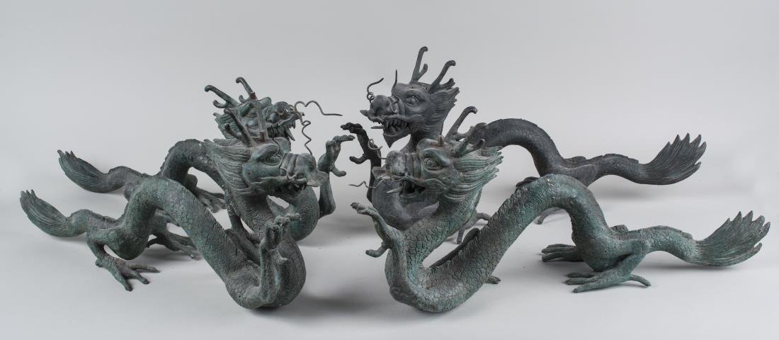 Set of Four Bronze Dragon Form Supports: Each modeled with one claw raised. Length 24 inches. Notice to bidders: Condition reports and additional photographs are provided by request as a courtesy to our clients, as such any condition report 