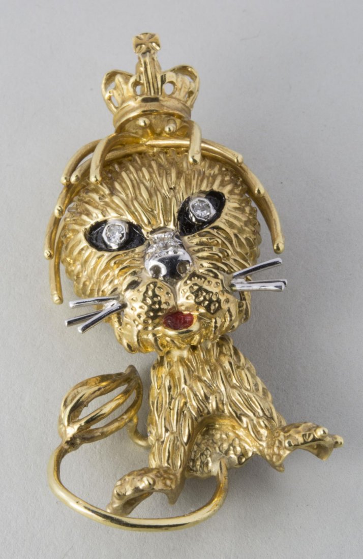Gold Lion Brooch Pin *: 18k yellow gold, in the style of Van Cleef and Arpels, with diamond eyes and nose, and wearing a crown. Height 2 1/2 inches. 18.0 grams. Notice to bidders: Condition reports and additional photographs