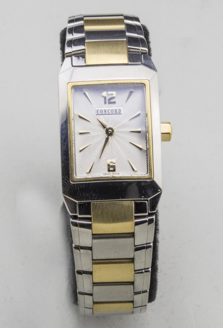 Lady's Concord La Scala Watch: Silvered metal dial with Arabic 12 and 6 and baton hours, no. 1302557, two tone stainless steel and 18k yellow gold band. Notice to bidders: Condition reports and additional photographs are provided b