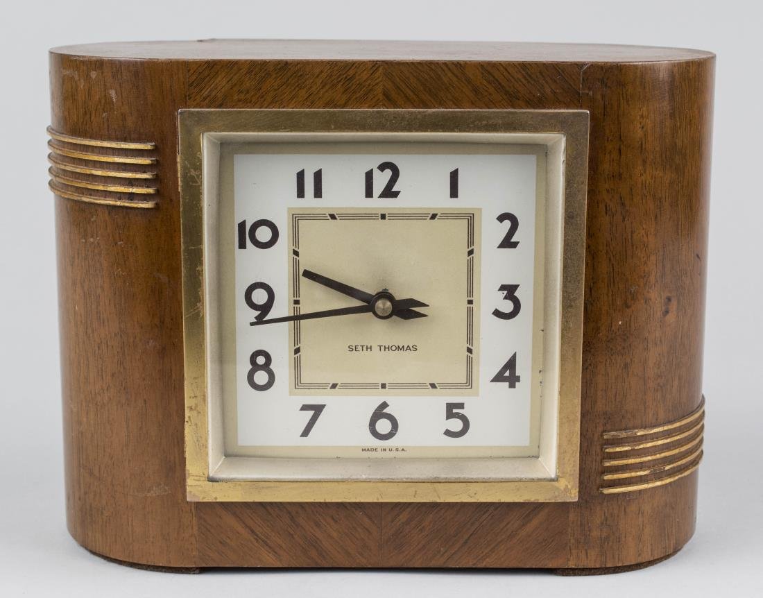 Seth Thomas Art Deco Clock: Dial with Arabic numerals. Height 7 1/2 inches. Notice to bidders: Condition reports and additional photographs are provided by request as a courtesy to our clients, as such any condition report is on