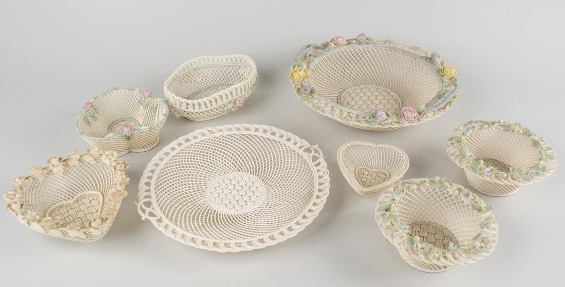 Group of Eight Belleek Baskets: Including a centerpiece basket, a circular tray, a heart shaped basket, a trefoil basket, a pair with floral borders, etc. Notice to bidders: Condition reports and additional photographs are provided