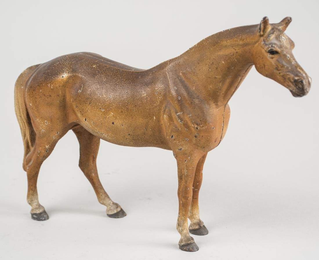 Cast Iron Horse: Cold painted. Height 8 inches. Notice to bidders: Condition reports and additional photographs are provided by request as a courtesy to our clients, as such any condition report is only an opinion and