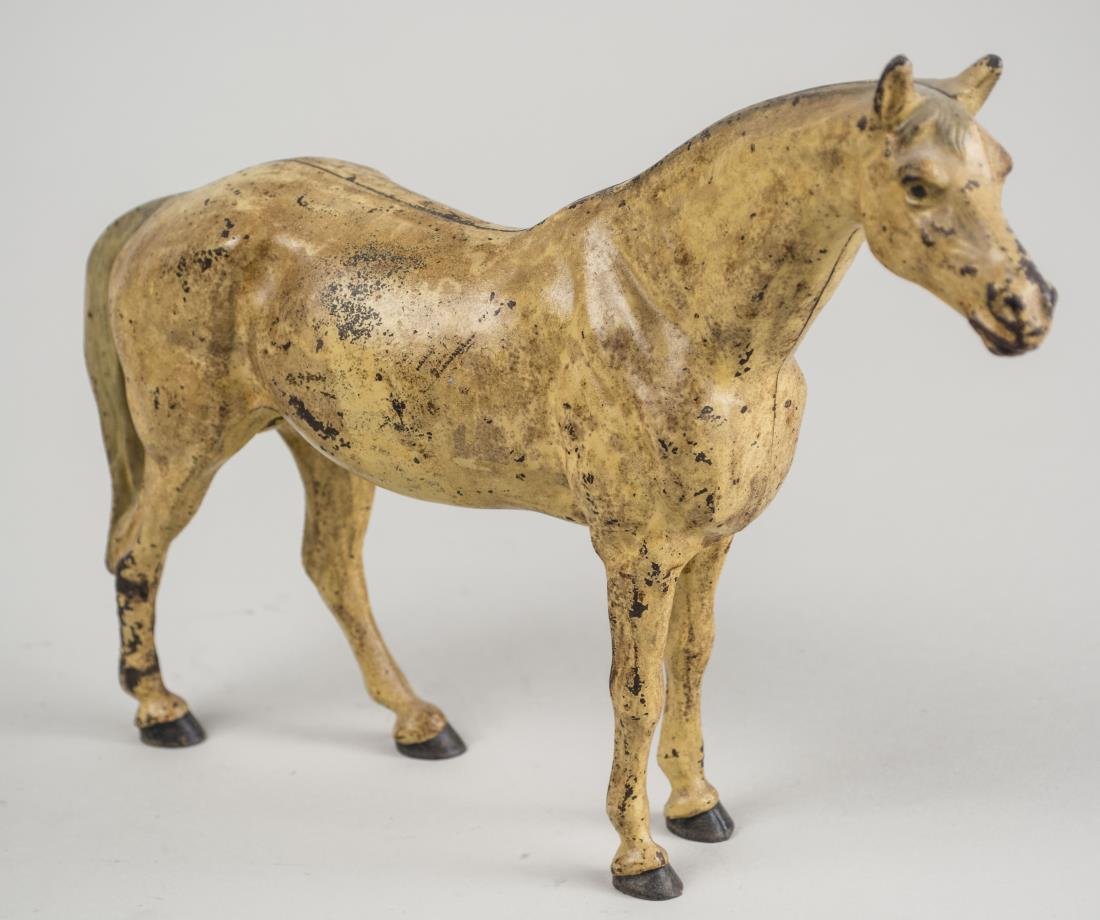 Cast Iron Horse: Cold painted. Height 7 3/4 inches. Notice to bidders: Condition reports and additional photographs are provided by request as a courtesy to our clients, as such any condition report is only an opinion