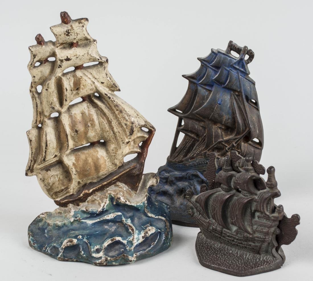 Two Cast Iron Doorstops and a Pair of Bookends: All with full-sail ship motif. Tallest height 9 1/2 inches. Notice to bidders: Condition reports and additional photographs are provided by request as a courtesy to our clients, as such any condition 