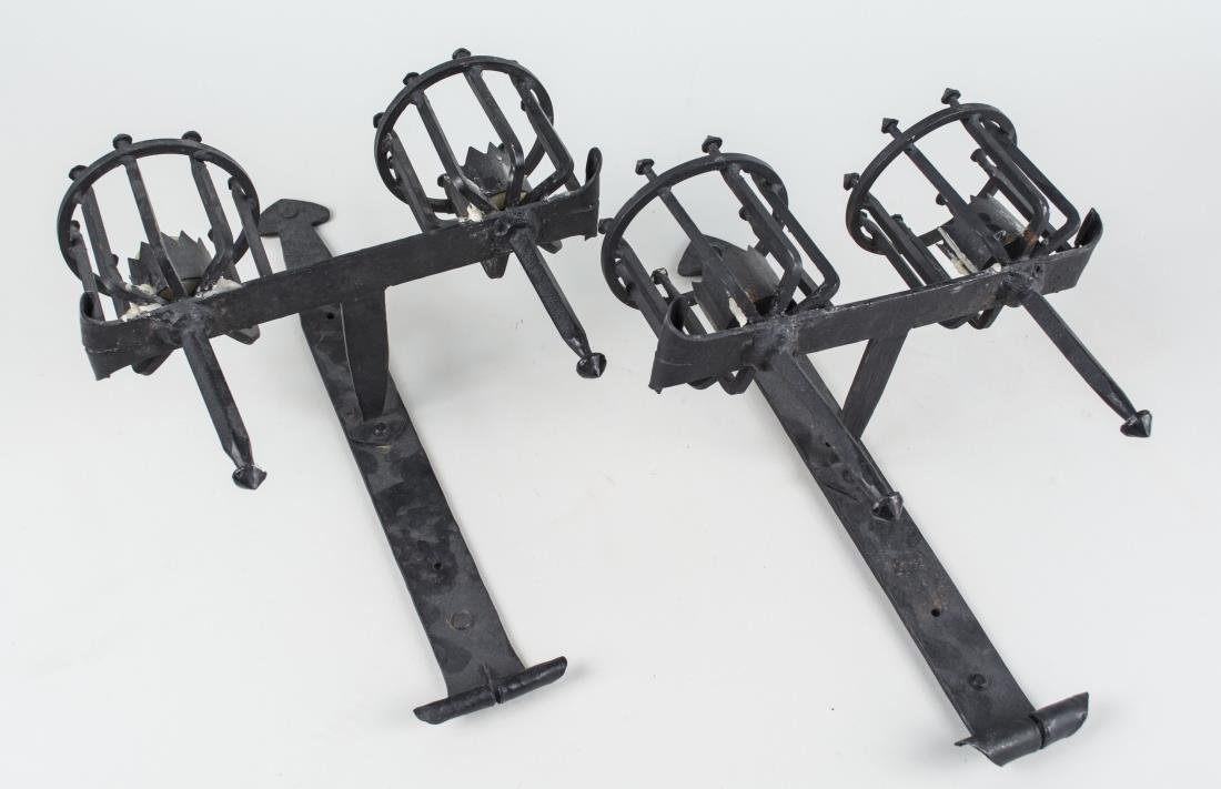 Pair of Wrought Iron Sconces: Gothic style, two lights. Height 15 3/4 inches. Notice to bidders: Condition reports and additional photographs are provided by request as a courtesy to our clients, as such any condition report is on