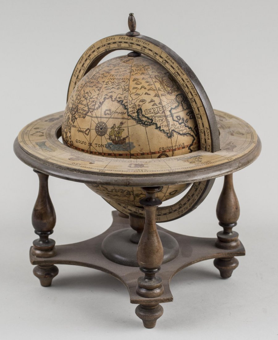 Desk World Globe: On a turned wood stand. Height 10 inches. Notice to bidders: Condition reports and additional photographs are provided by request as a courtesy to our clients, as such any condition report is only an 