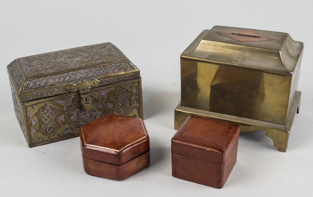 Four Decorative Boxes: Two brass boxes and two small leather boxes. Tallest height 4 1/2 inches. Notice to bidders: Condition reports and additional photographs are provided by request as a courtesy to our clients, as such