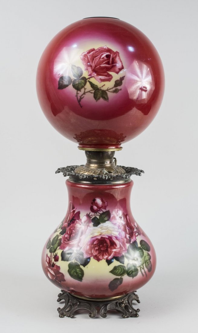 Gone with the Wind Lamp: Flower decorated lamp and glass shade. Height 27 1/2 inches. Notice to bidders: Condition reports and additional photographs are provided by request as a courtesy to our clients, as such any condition