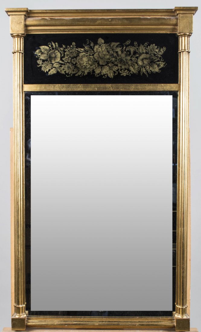 Gilt Wood Eglomise Mirror: Molded cornice over a eglomise panel with floral decoration and a rectangular mirror plate, flanked by reeded columns. 35 x 20 3/4 inches. Notice to bidders: Condition reports and additional photograp